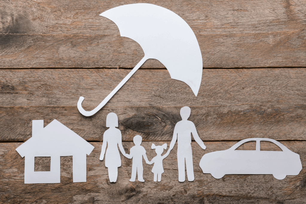 paper cut out of a family and car and umbrella